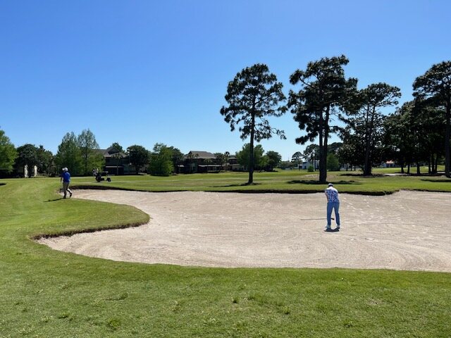 A veteran hitting out of a greenside bunker
