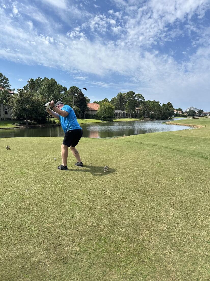 A veteran swinging on the fairway