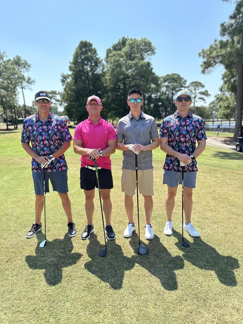 Four veterans in matching tropical shirts